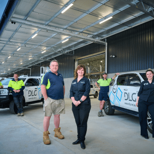 DLG Aluminium & Glazing team members standing with company vehicles