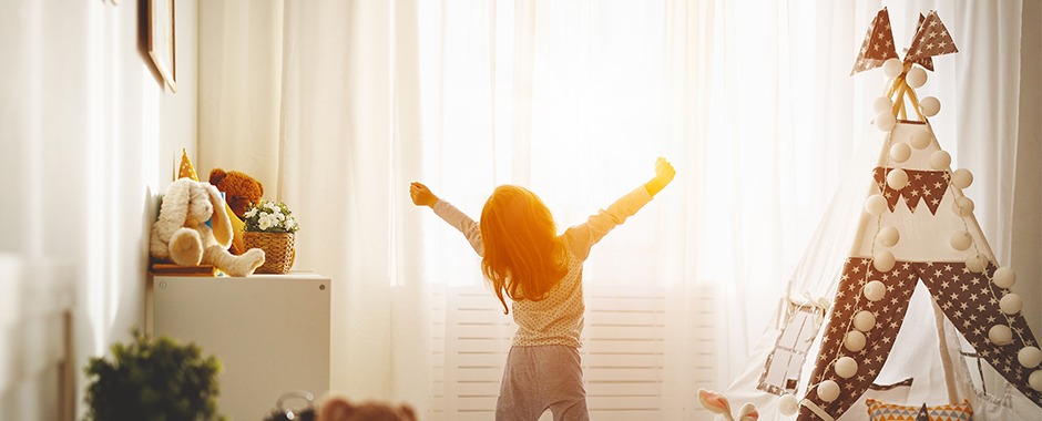 a child extending his hands in front of an installed residential awning window